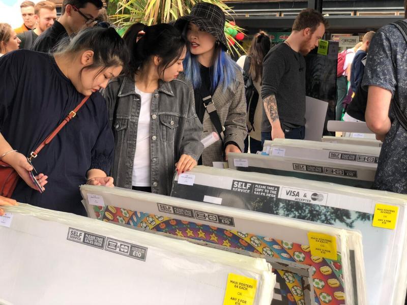 New students at the Freshers Fair poster sale, picking out new art and posters for their halls accommodation